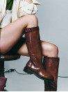 bota café de cuero para mujer, estilo casual, con caño alto y hebilla decorativa, ideal para ocasiones formales y casuales.