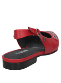 Detalle de ojales asimétricos en la parte delantera del zapato de cuero rojo.