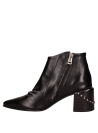 Elegante botín urbano en cuero negro con caña al tobillo, perfecto para combinar con jeans o falda midi.